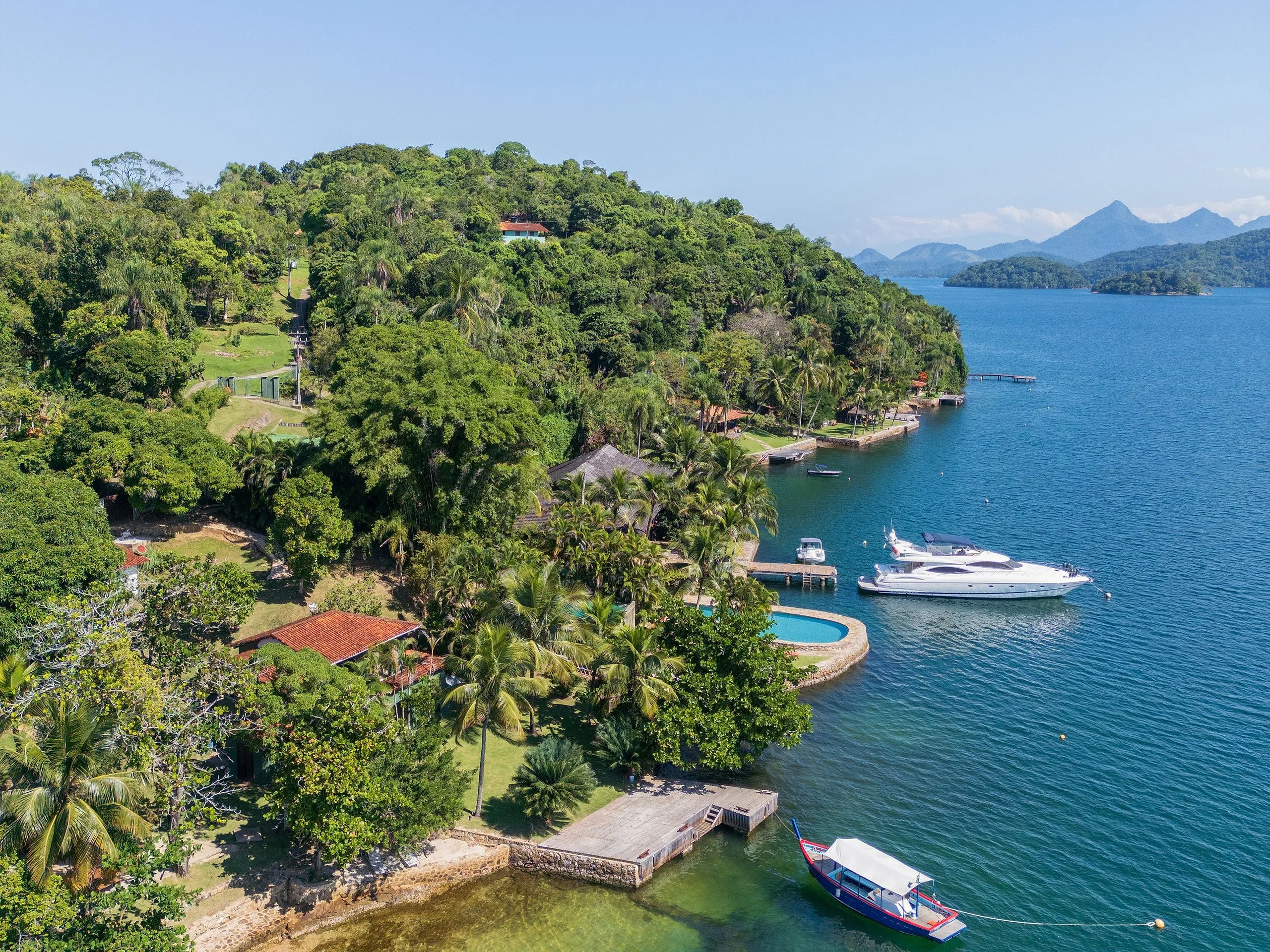 Island coast with a motorboat, seen from above
